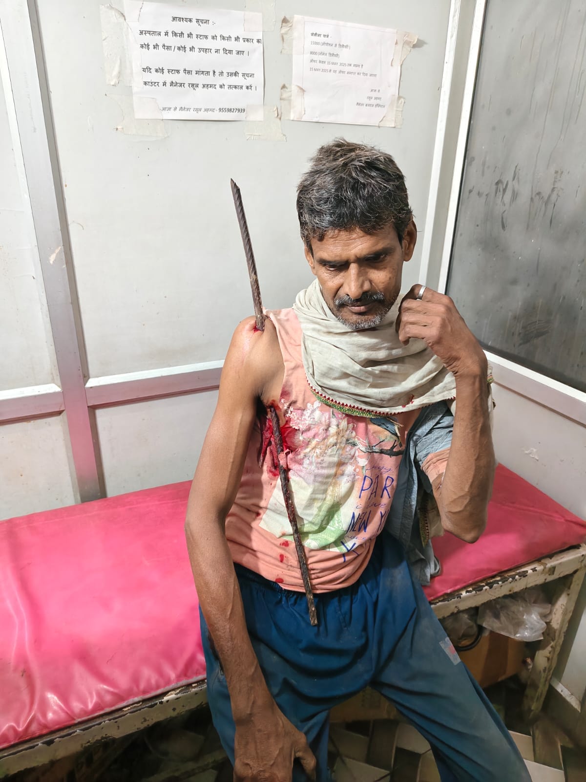 A worker fell while demolishing a roof and a bar pierced his shoulder.