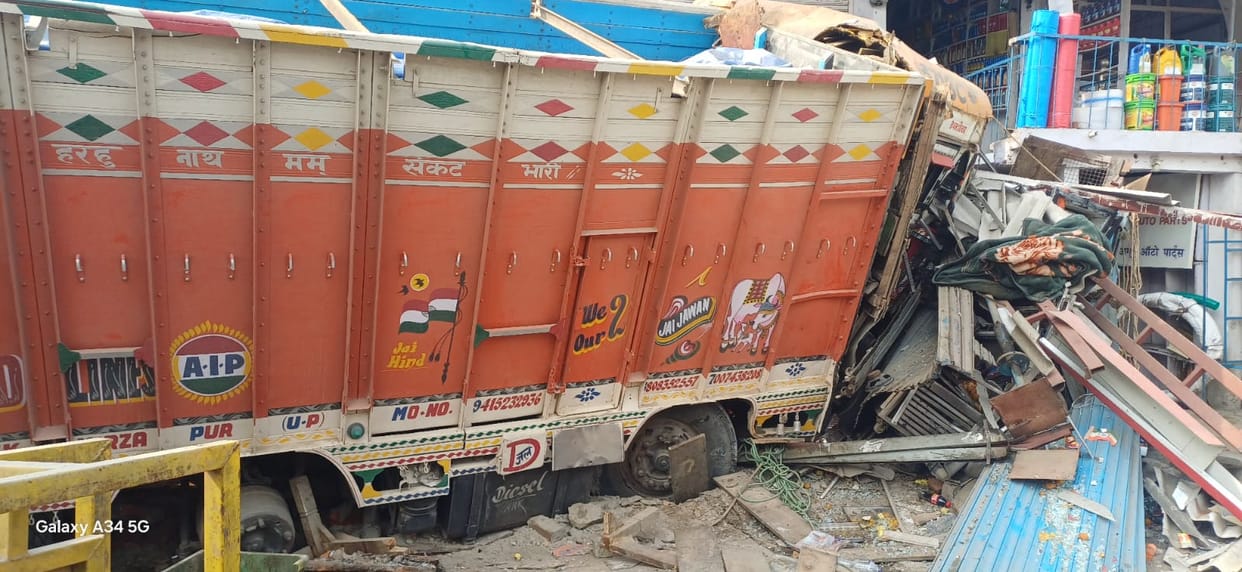 Two trucks went out of control and rammed into a shop, injuring four.