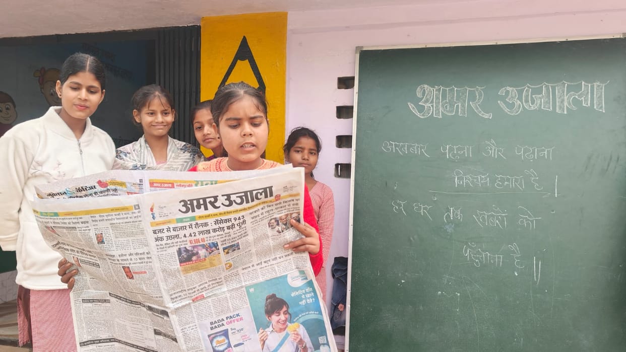 Students becoming aware by reading newspapers in prayer meeting