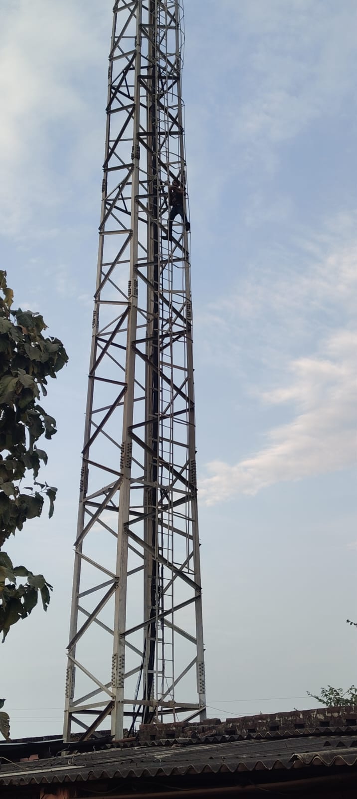 A madman climbed a telephone tower and came down after an hour of drama.
