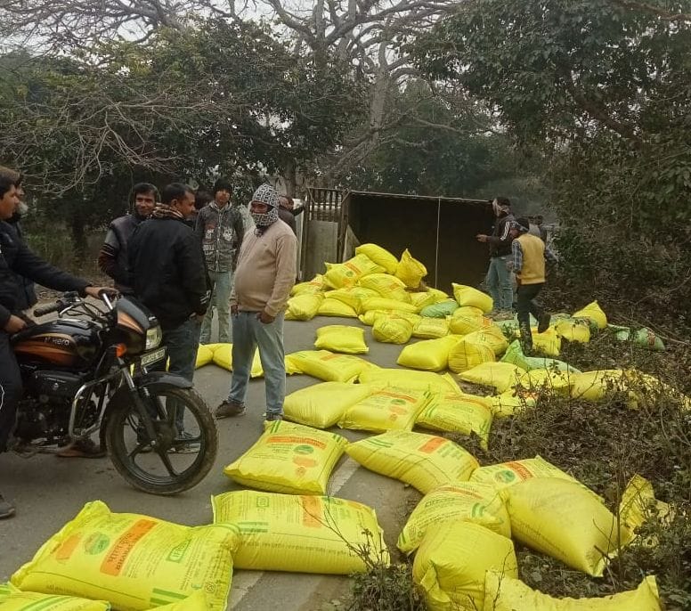 Sacks spilled onto the road after a pickup truck overturned, causing a traffic jam.