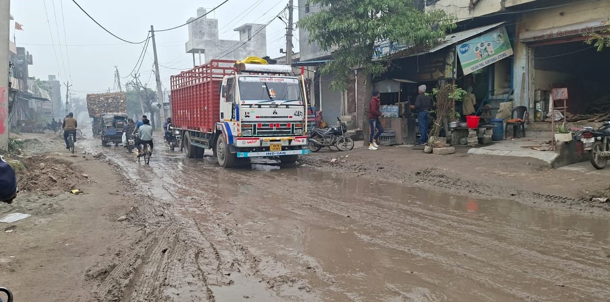 Young children have to trudge through mud every day to get to school