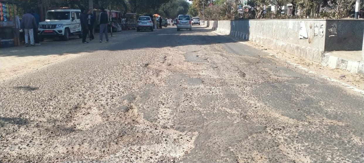 The new identity of Model Road... deep potholes, broken tiles, and dried-up plants.