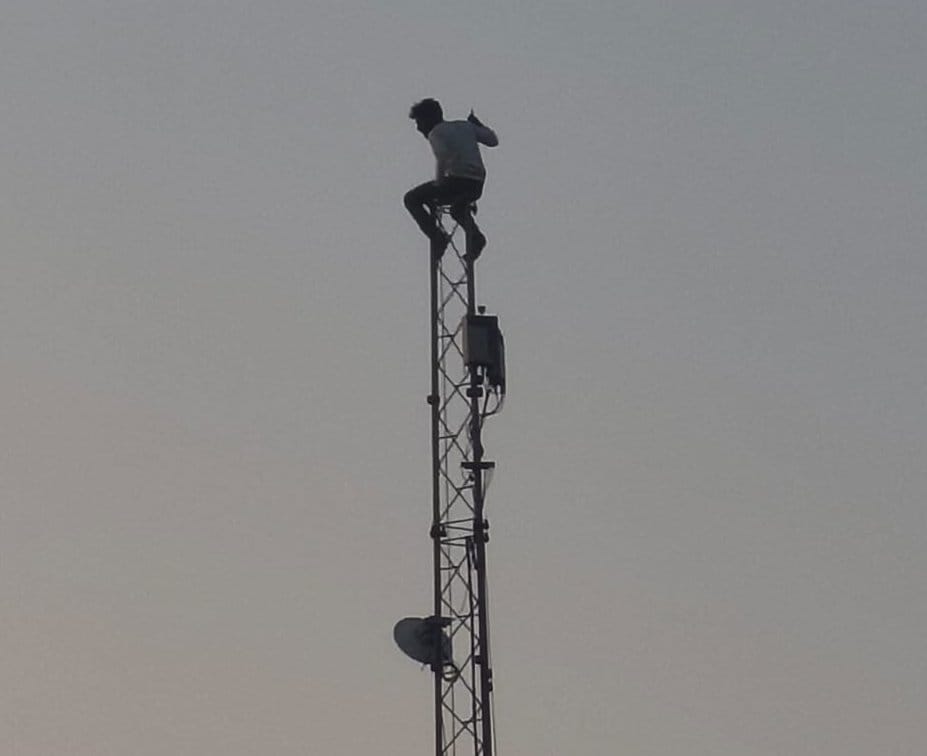 Drunk man climbs mobile tower