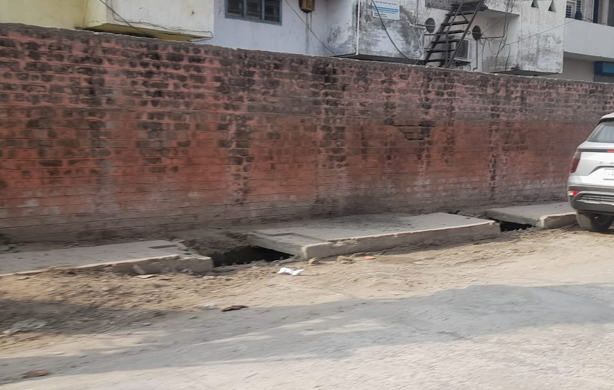 The drain cover remains open outside the vegetable market.