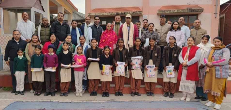 Dharampal, a former student, honored the meritorious students.