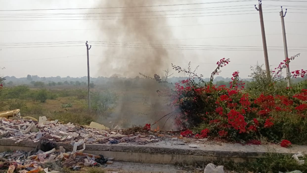 Garbage burning on the highway, people are choking on the smoke