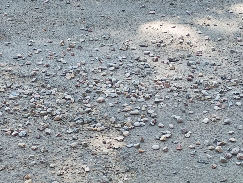 Overloaded and over-speeding tippers are causing gravel to fall on the road, leading to accidents.