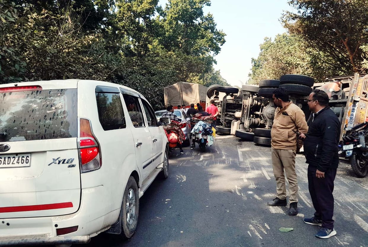 A truck loaded with paddy overturned, causing a four-hour traffic jam on the highway.