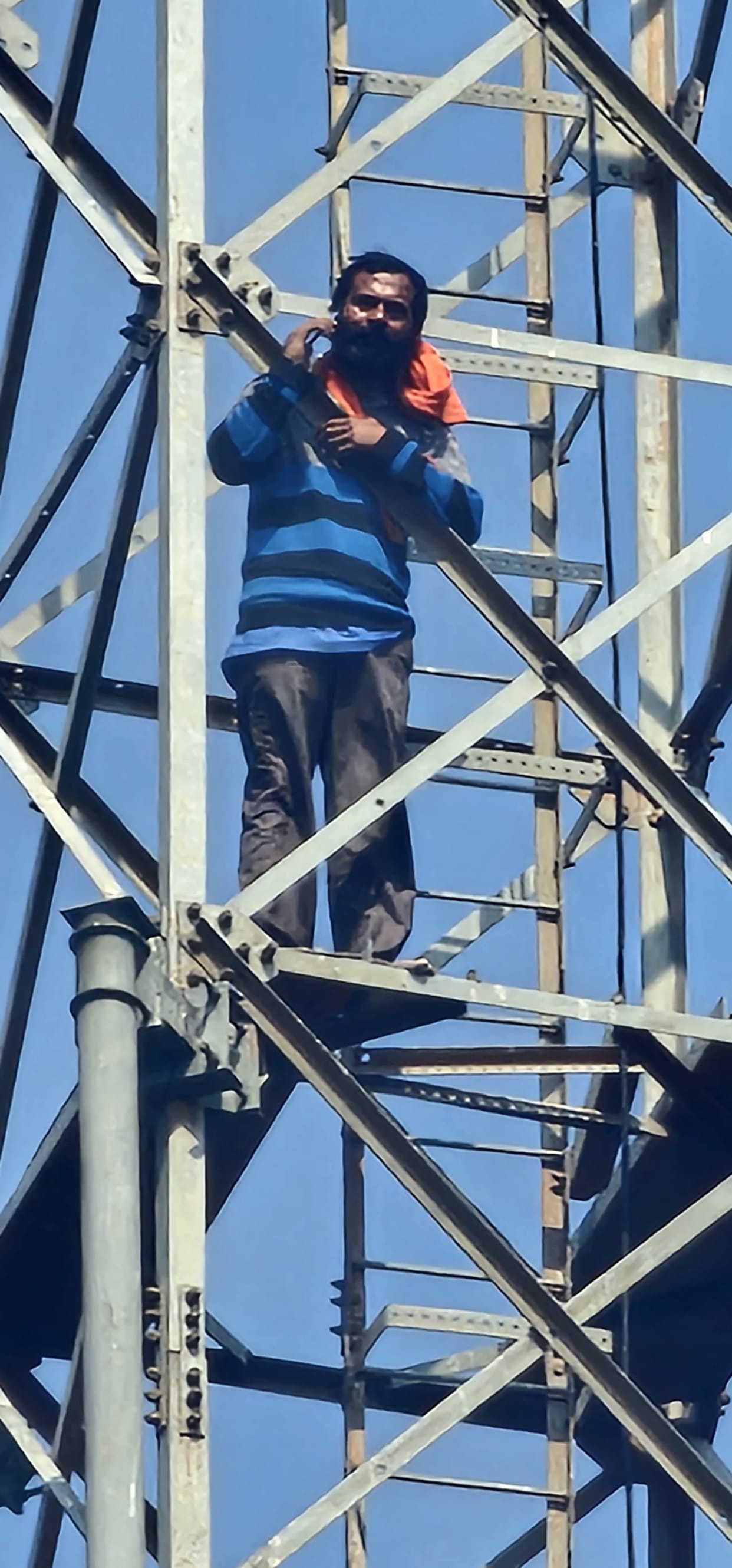 A young man climbed a mobile tower over a land dispute and came down after three hours.