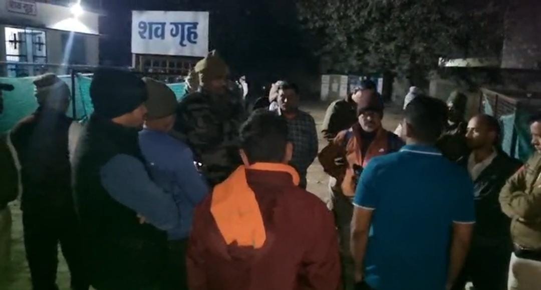 शव गृह के पास खड़े लोग।