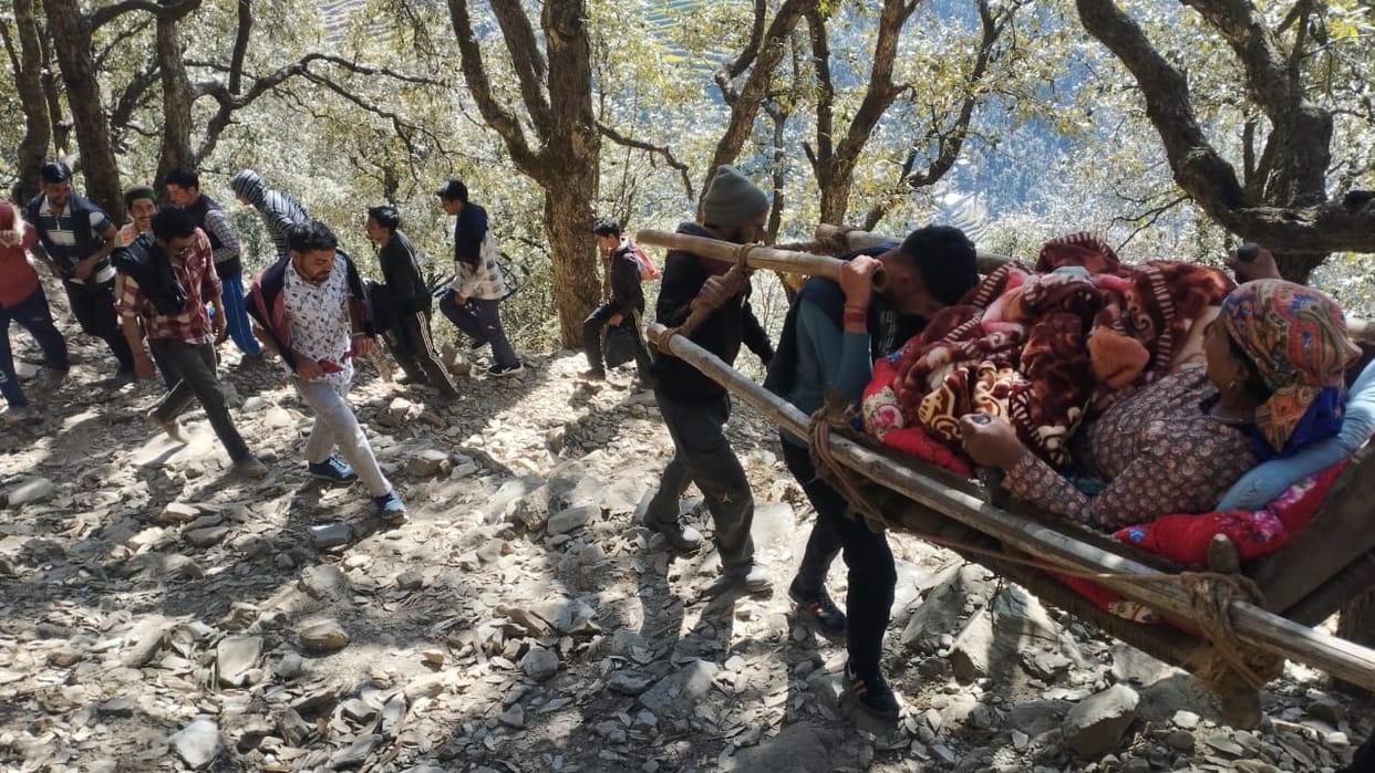 Unable to walk, woman carried 15 km on palanquin to reach road