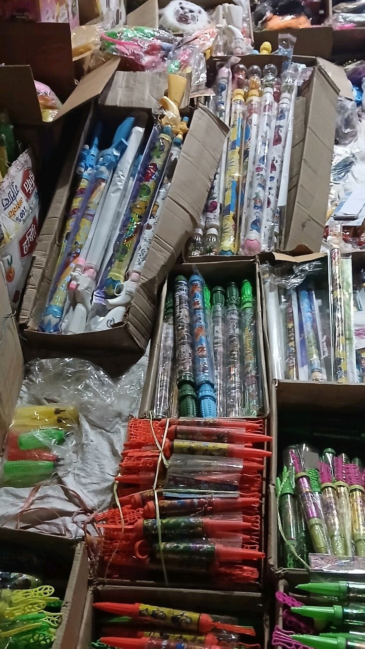 Holi colors are visible in the market, increasing the excitement