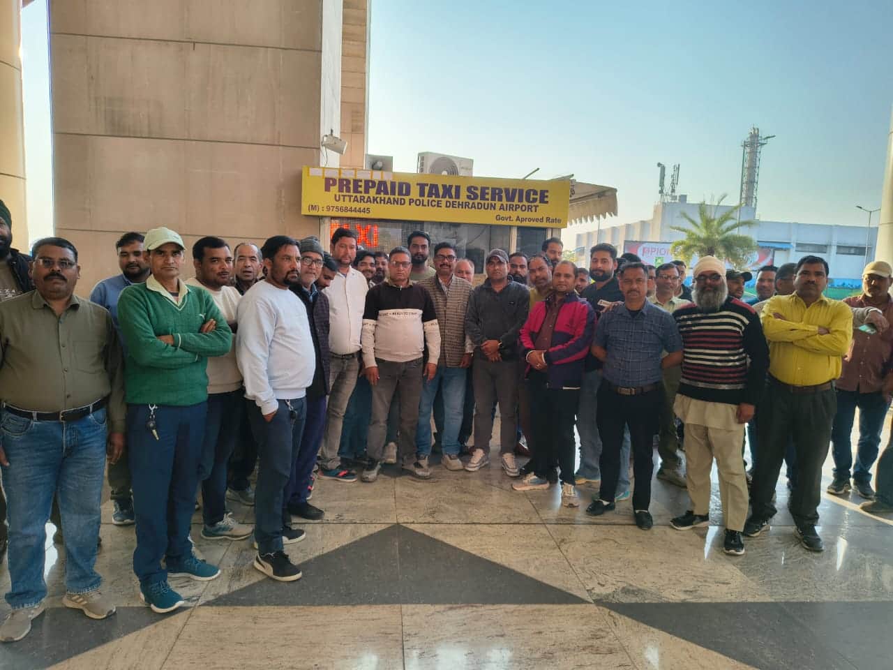 प्रीपैड टैक्सी काउंटर के पास मौजूद एयरपोर्ट टैक्सी चालक: संवाद