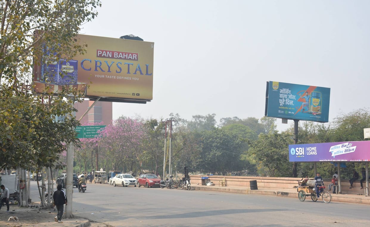 Dangerously placed billboards at intersections, missing them could result in injuries.