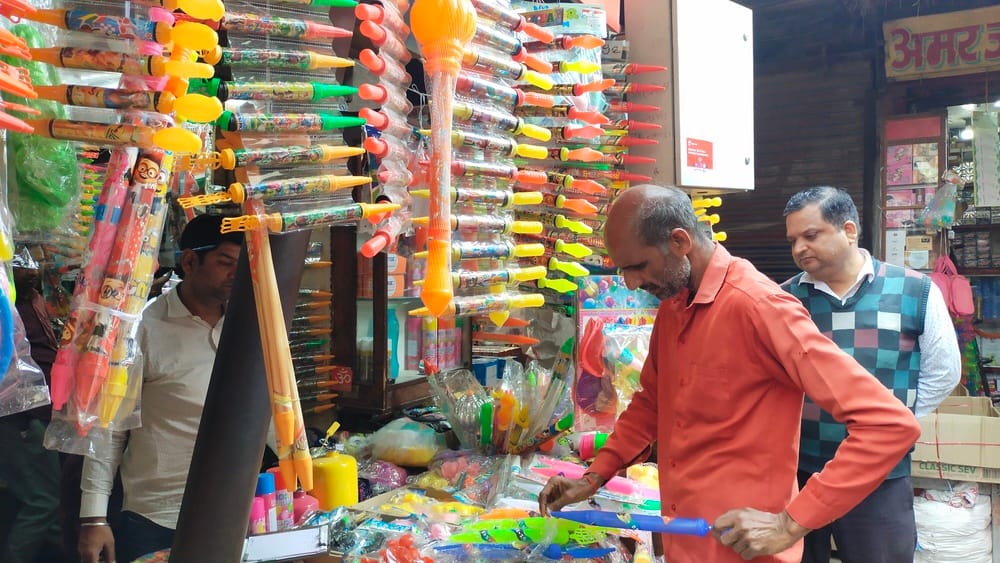 The market is buzzing with colours before Holi