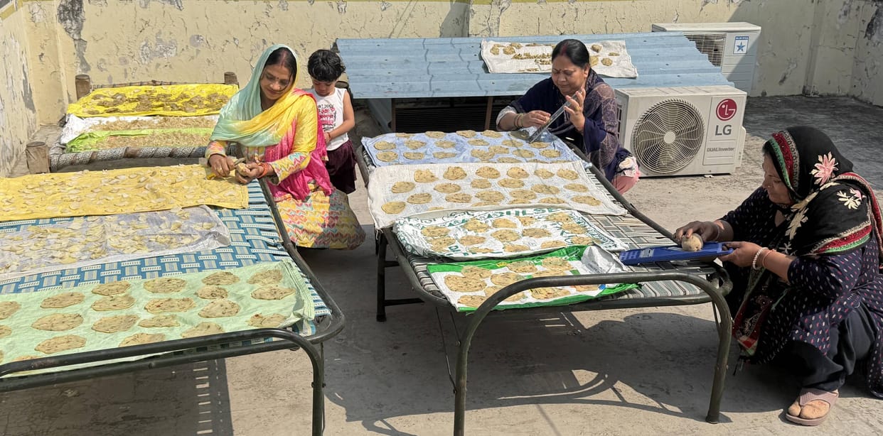 Women are busy preparing for Holi, making papad at home.