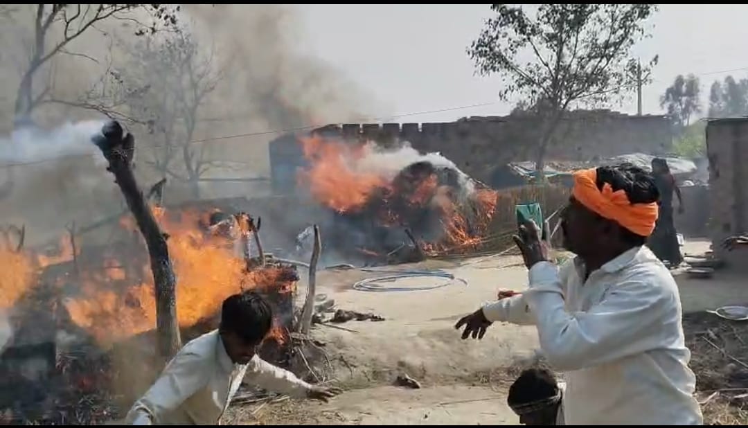 Three huts were gutted in the fire, leaving household items in ashes.