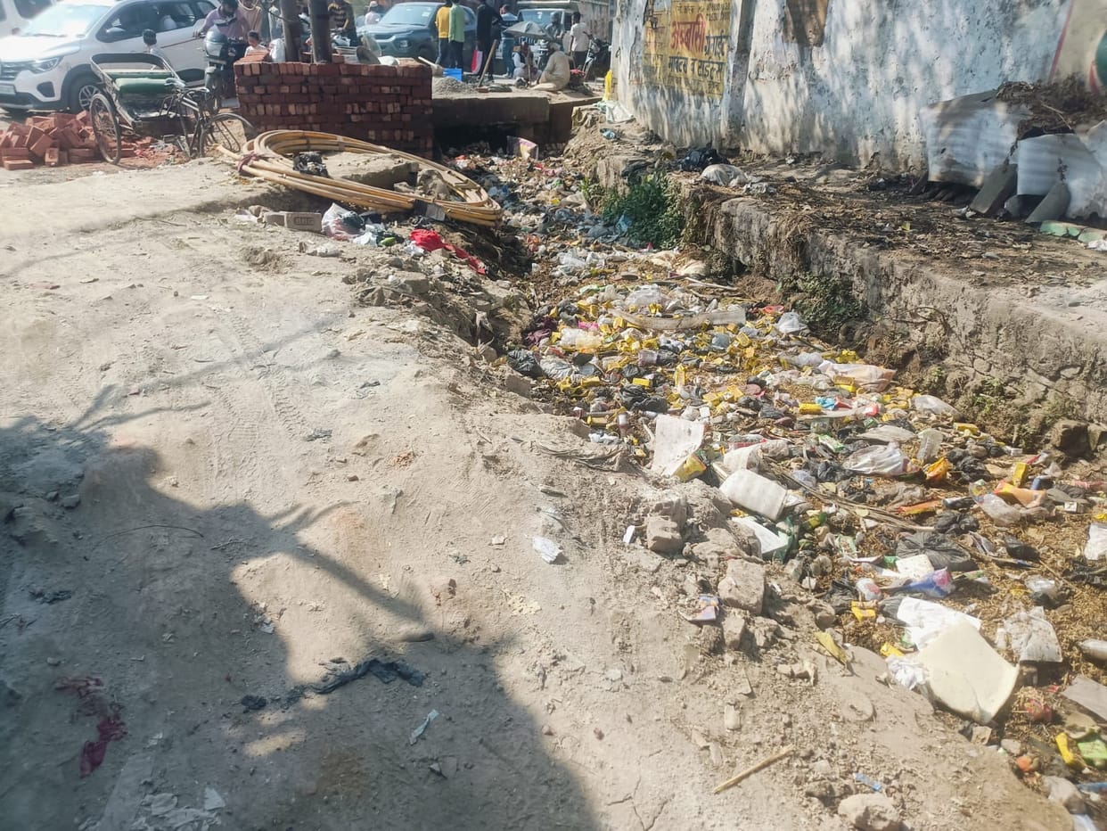 Piles of garbage near the religious site, people are angry due to lack of cleaning of drains.
