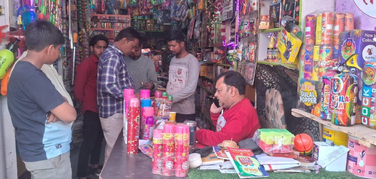 Holi market decorated with water guns and herbal colours