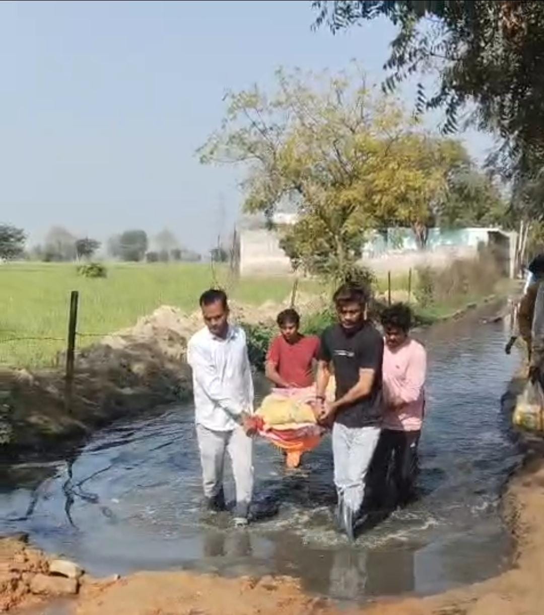 Family members walked through the mud carrying the woman's bier.