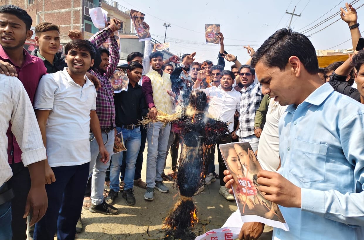 Protest by burning the effigy of the film director
