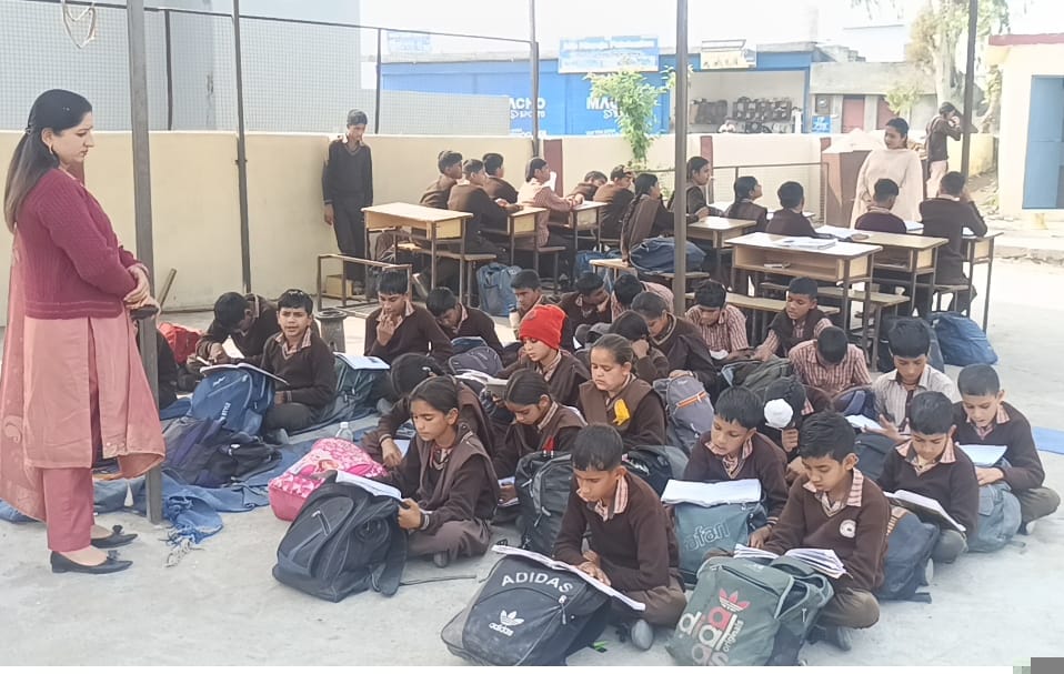 Four years after the upgrade, classes are still being held under the open sky.