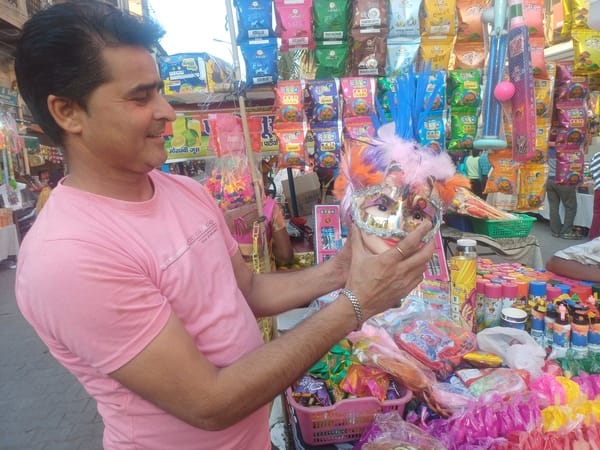 People are enjoying masks, colorful wigs and magic balloons.
