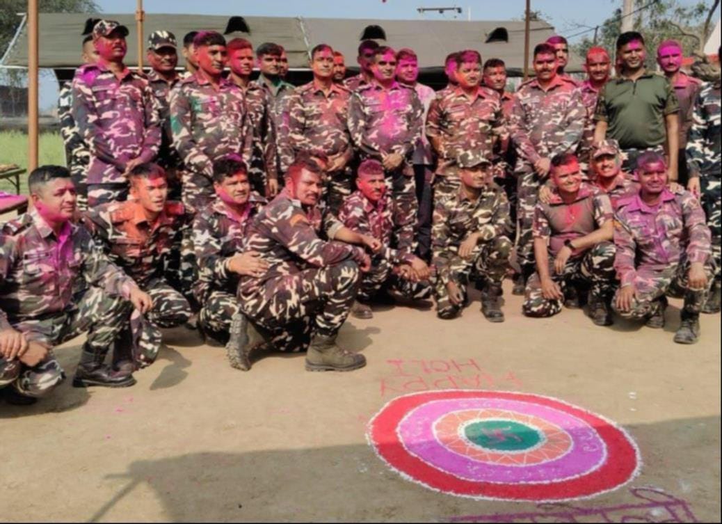 The commandant played Holi with the soldiers.