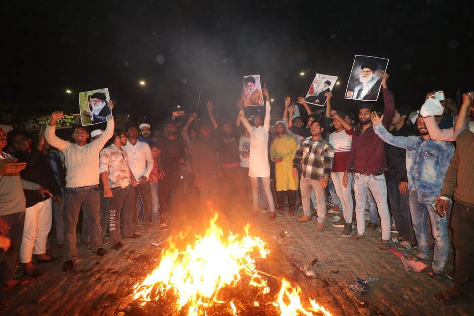 People gathered at night, expressing grief and anger over Khamenei's assassination.