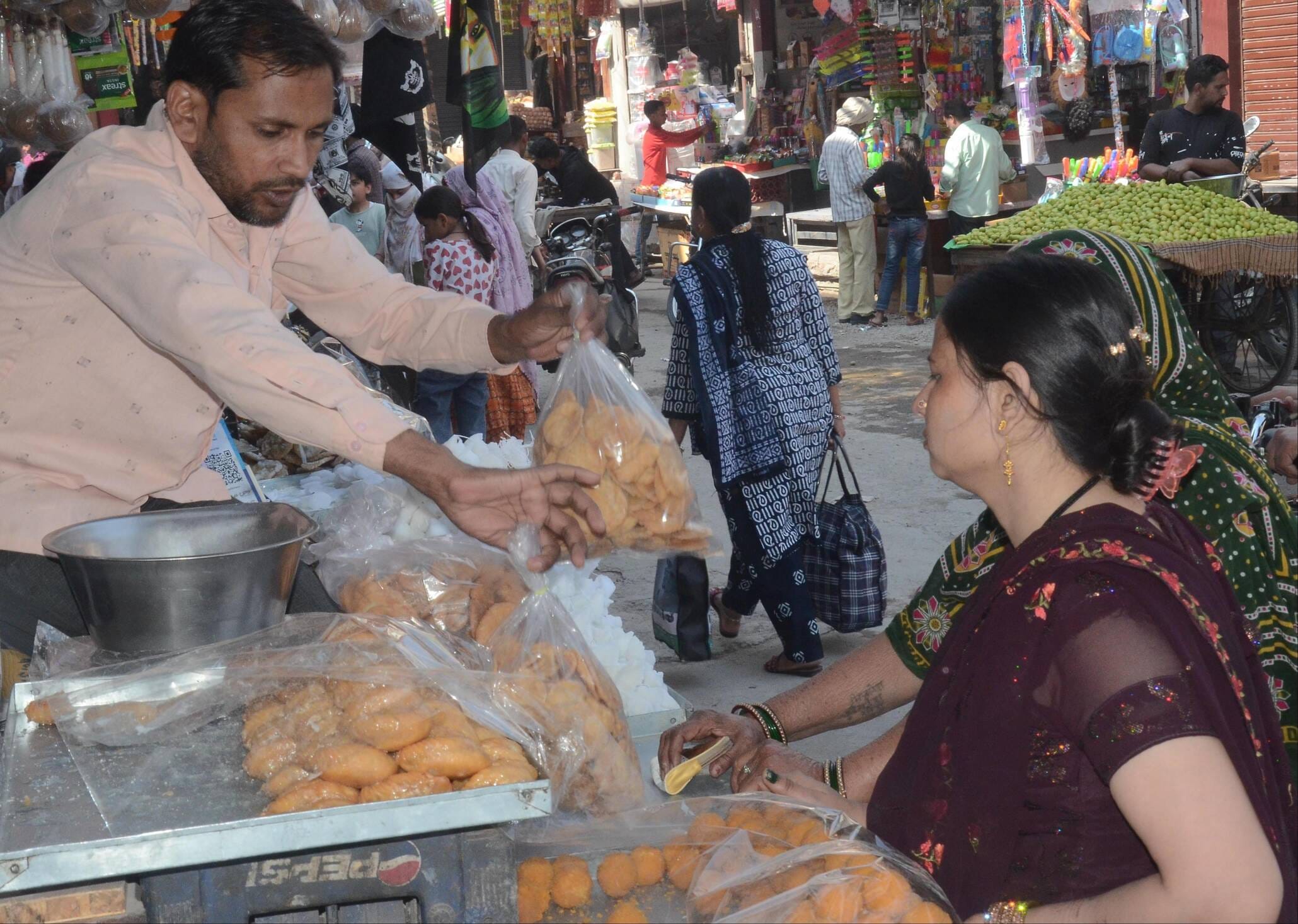The market was vibrant, with plenty of purchases of gujiyas, gulal and squirt guns.