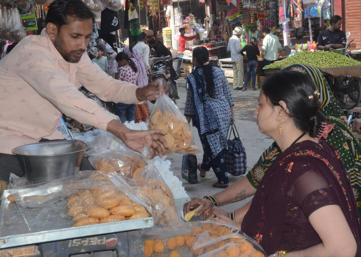 The market was vibrant, with plenty of purchases of gujiyas, gulal and squirt guns.