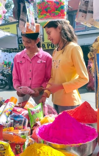 The markets were buzzing with the fragrance of colours and gulal.