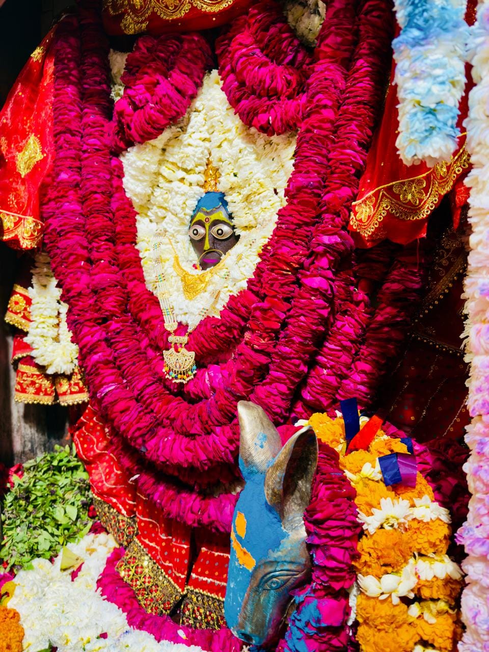 Mother was adorned with chunari, chrysanthemum and red roses.