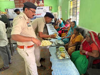 Police and volunteers celebrate Holi the day after.