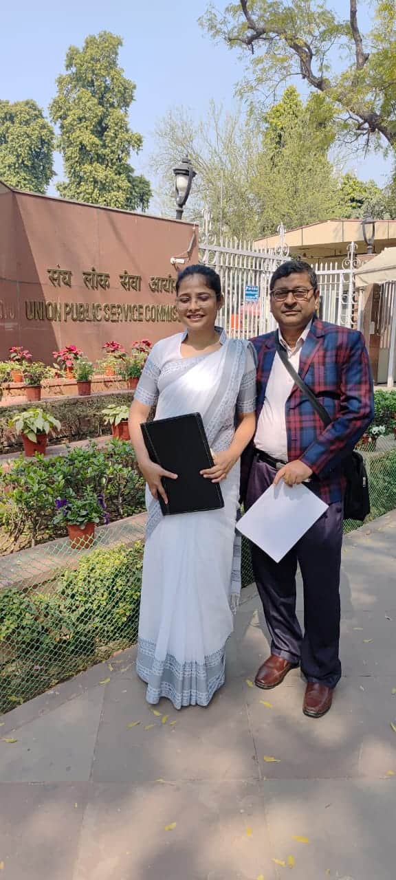 टॉपर जूही दास को मिठाई खिलाते हुए परिजन