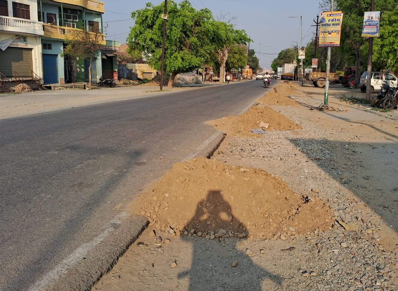The stalled road widening work in Ujhani resumed.