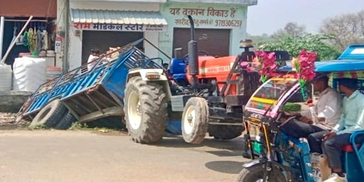 A trolley loaded with wheat overturned in a drain due to cracked footpath.