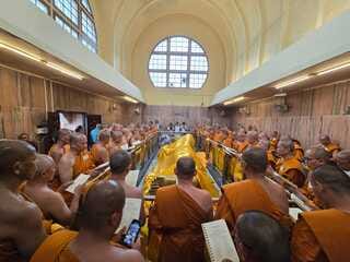 Thai Buddhist monks bow their heads to the Buddha