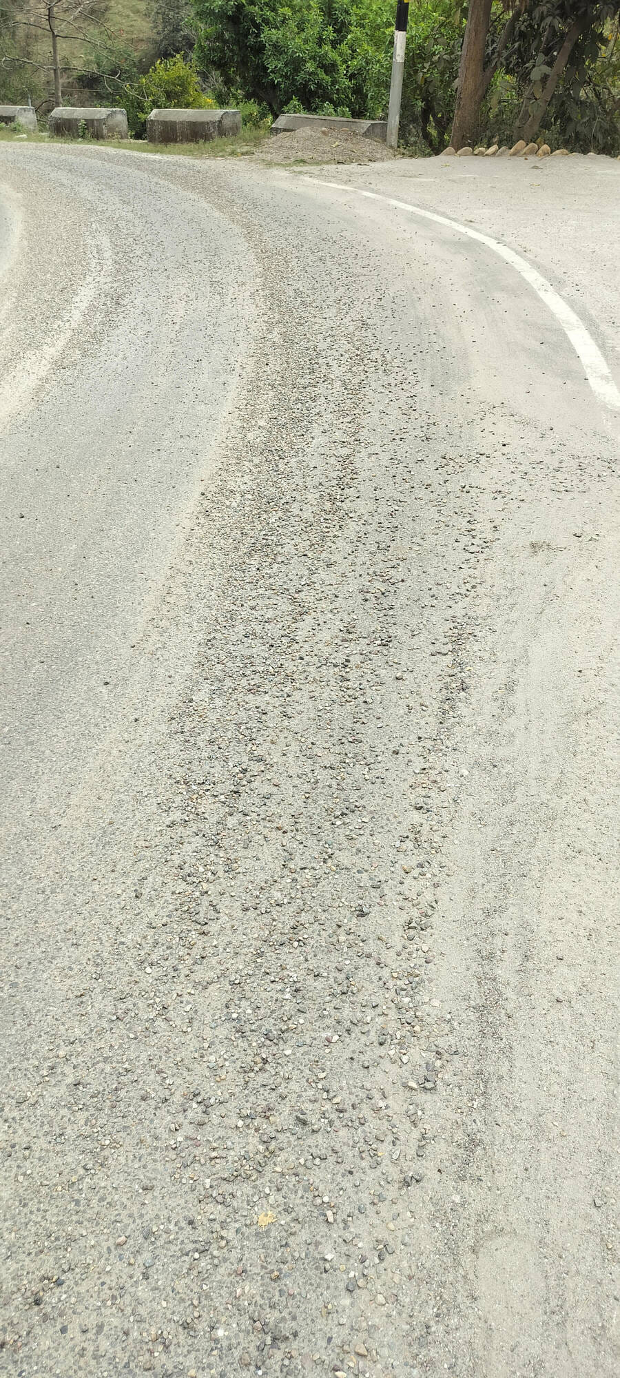 Overloaded tippers causing sand and gravel to fall on the road