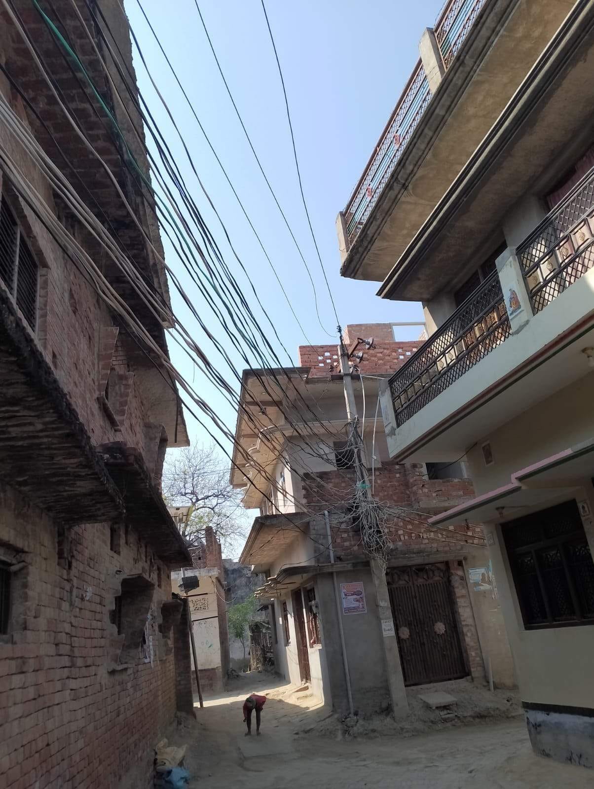 The streets of Daudpur are entangled in a web of wires.