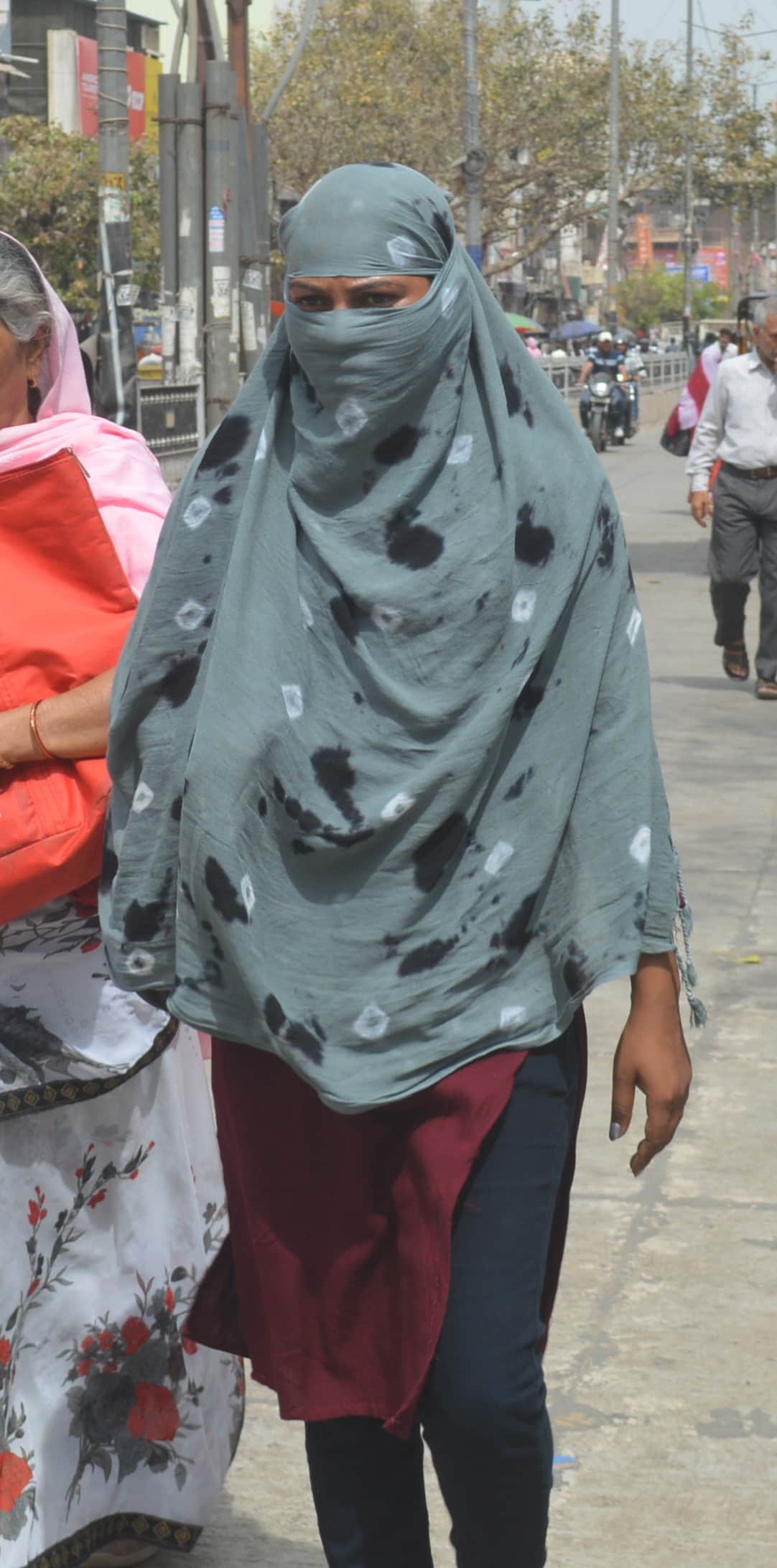 धूप में गुजरती युवती। 