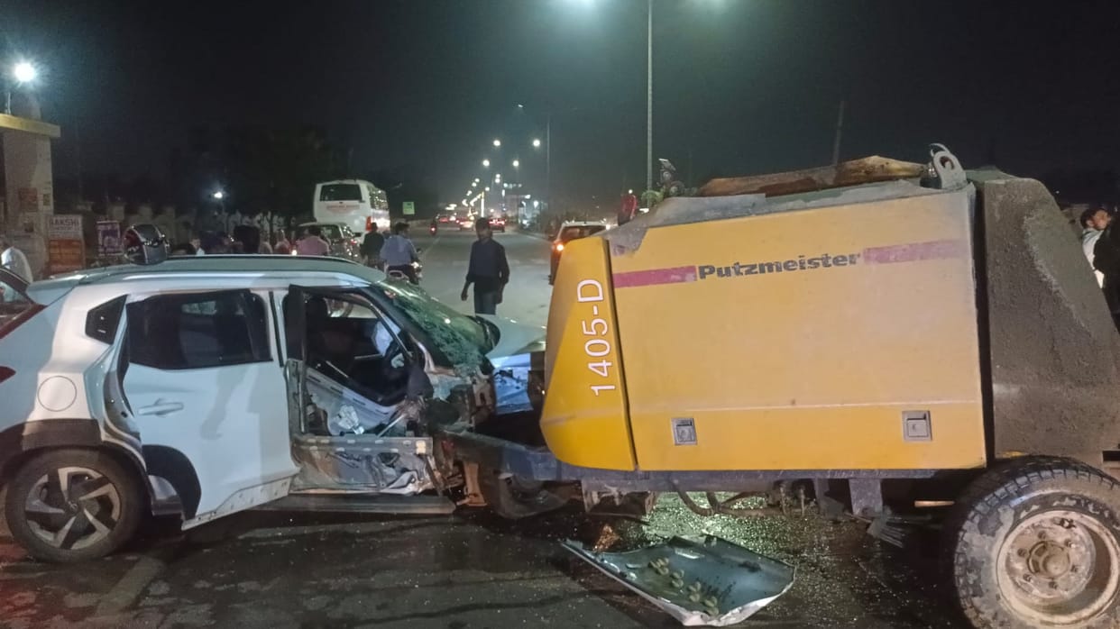 Concrete pump machine crosses divide and hits car, four people injured