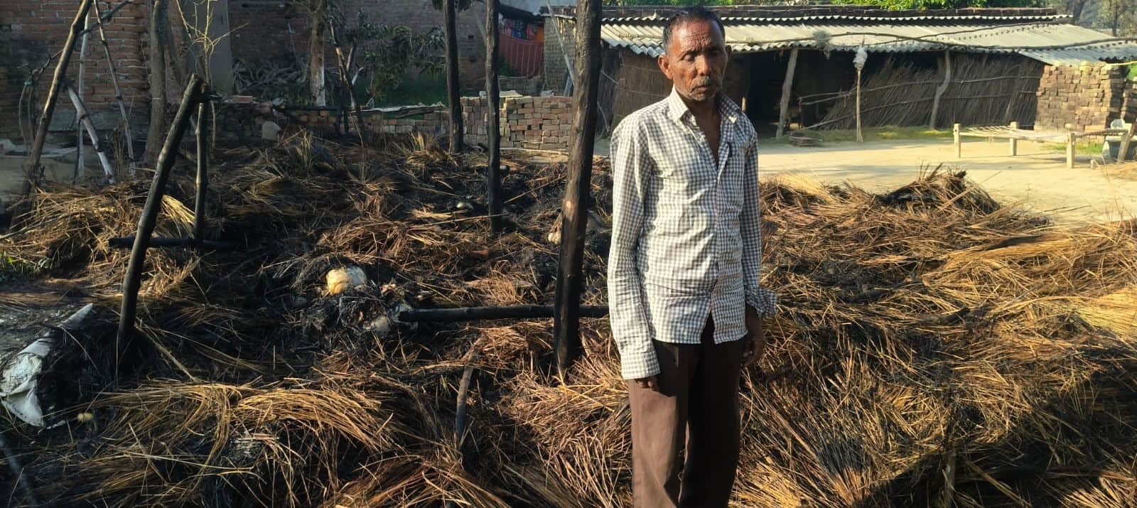 भीमपुरा क्षेत्र के कुशहा रसीदपुर गांव में अज्ञात कारणों से लगी आग के जले पड़े सामानों को देखता 