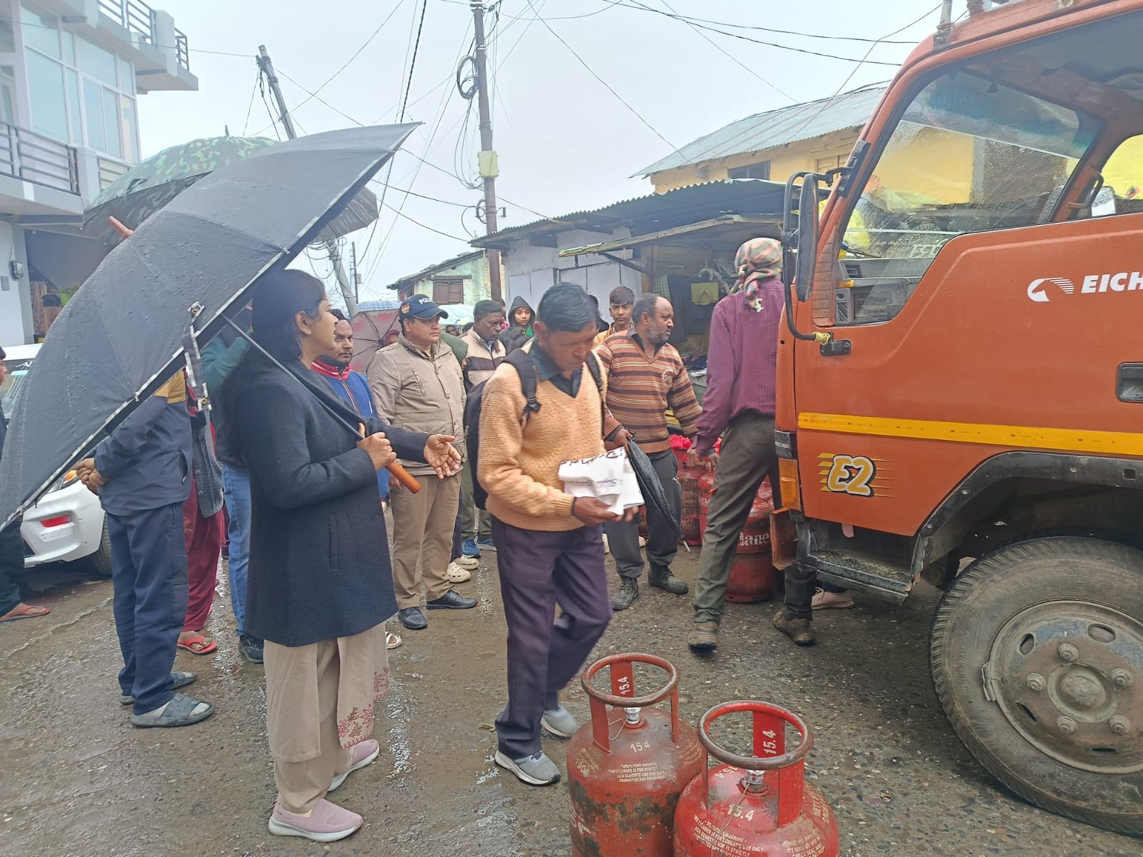 Despite the rain, people waited for hours to get gas in Ranikhet.