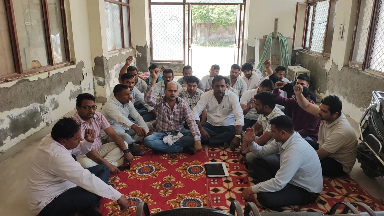 Electricity workers staged a sit-in protest alleging that the Sarpanch threatened to shoot them.