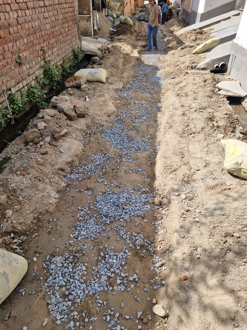 गली निर्माण से पहले रोडी डलवाने में की जा रही खानापूर्ती।  संवाद