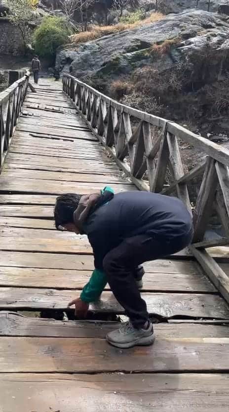 खुडवा में खस्ताहाल लकड़ी का पुल दिखाते हुए स्थानीय लोगजागरूक पाठक