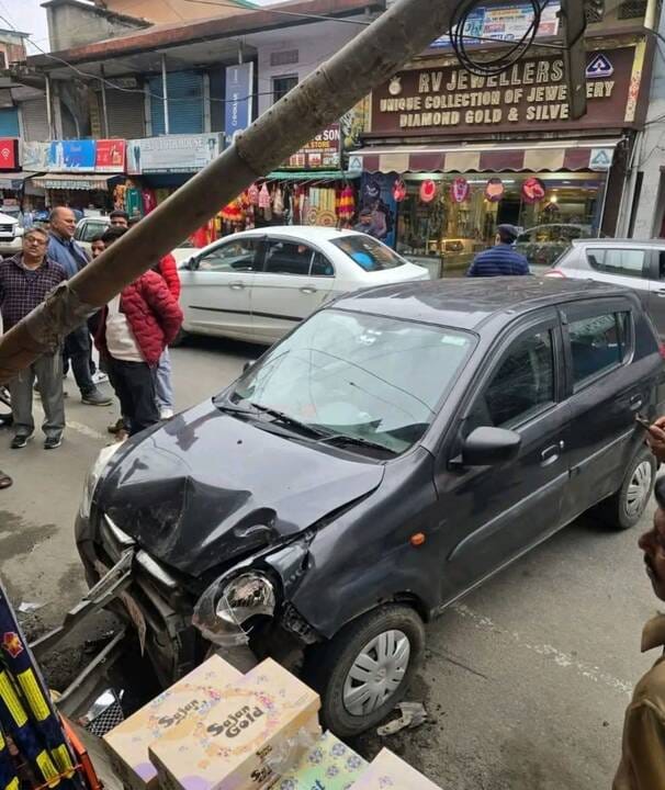 Scooty and bike damaged after being hit by a car that collided with a pole
