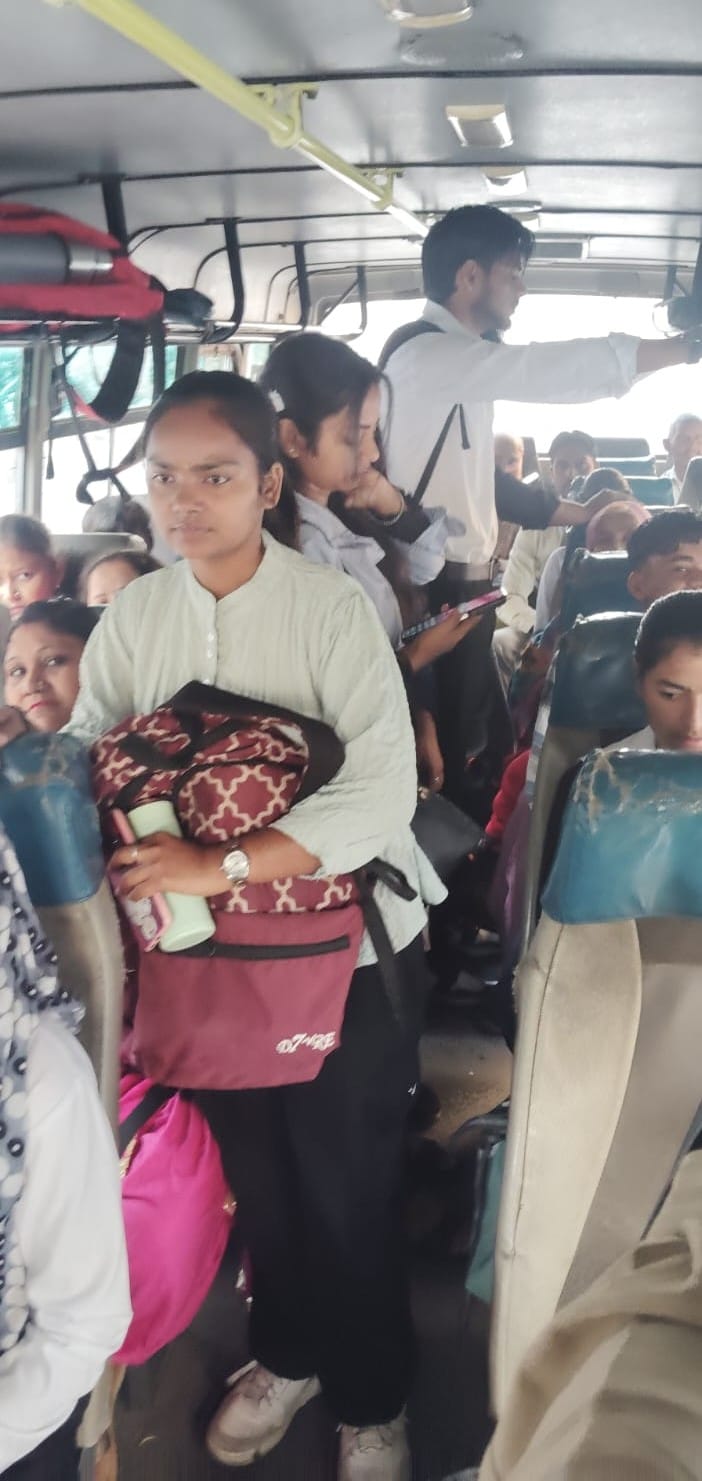 The condition of the pink bus... men are also travelling along with women.